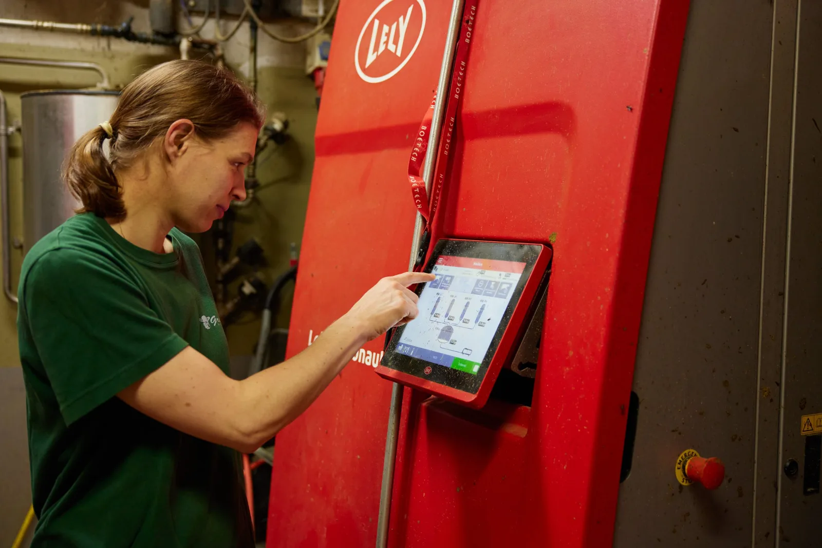 Bedienung des automatischen Melksystems im Stall, Arbeitskleidung mit dem Greber-Zeichen